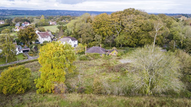 A three-bedroom detached bungalow on a c1 acre plot in a secluded spot in the sought-after Abbots Leigh. A rare find, offering potential for development STPP.